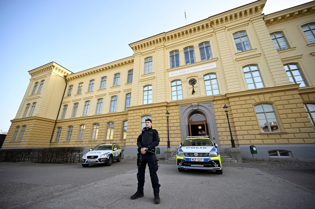 A policeman stands outside the Malmö Latin School in Malmö, Sweden Tuesday, March 22, 2022.