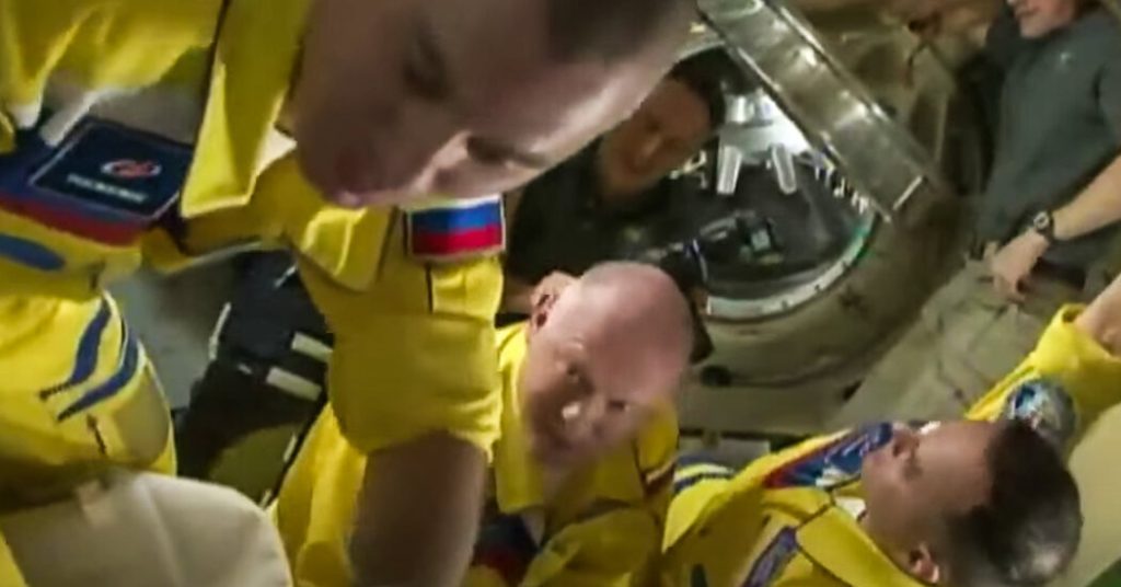 A painting of Russian ISS cosmonauts in colors similar to the Ukrainian flag
