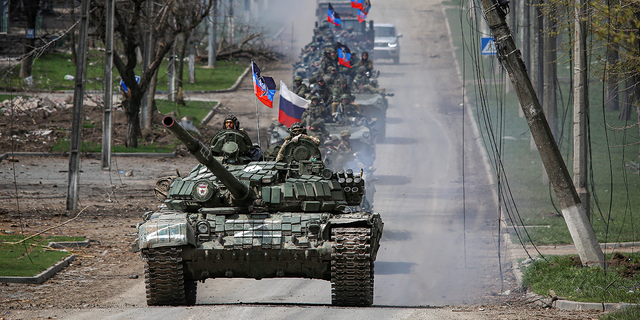 A convoy of pro-Russian forces moves along a road in Mariupol, Ukraine, on Thursday, April 21.