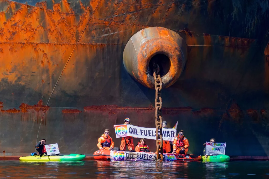 Greenpeace Ukraine protesters tie a kayak to a Russian oil tanker