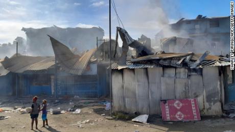 Smoke rises from burning buildings in Chinatown in Honiara on November 26, 2021 after two days of rioting.