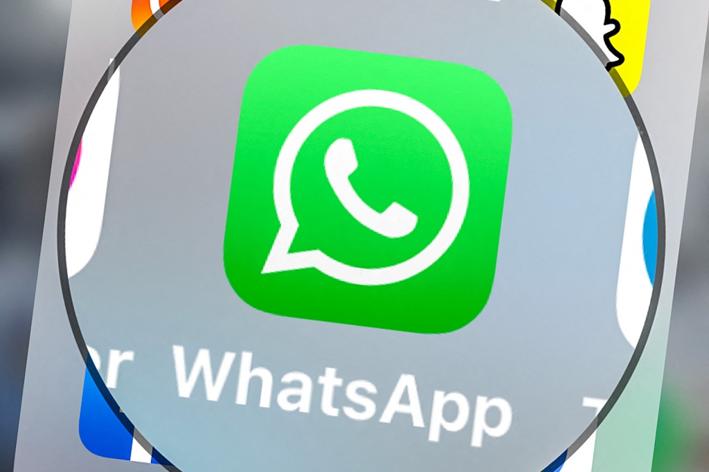 This image taken on March 23, 2022 shows the logo of the instant messaging program and calling service Whatsapp on a tablet in Lille, northern France. 