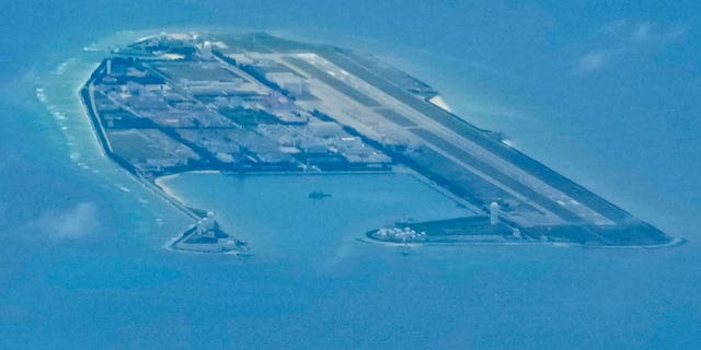 Chinese structures and buildings appear on the man-made Fiery Cross Reef in the disputed group of Spratlys islands in the South China Sea on March 20, 2022. 